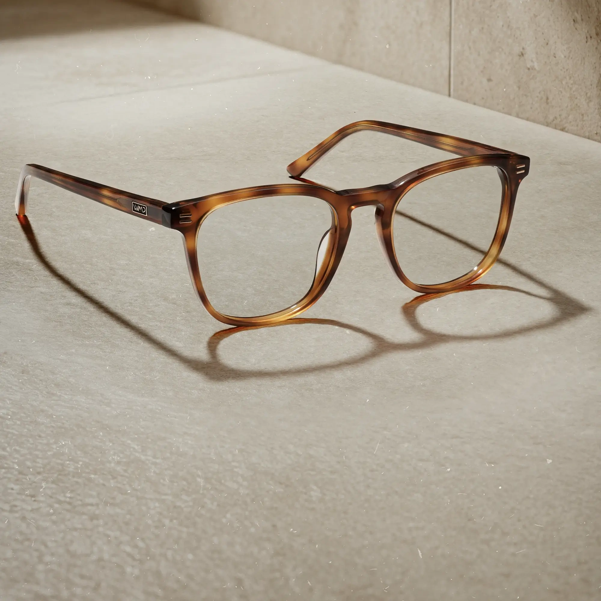 WMP Eyewear Nick prescription eyeglasses in Saddlewood Tortoise, featuring a warm tortoise rounded square frame with clear lenses.
